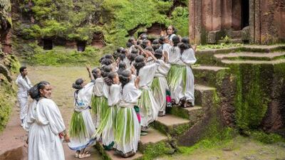 Girls with the traditional 'Ashenda Grass' tied around their waists, celebrate at the Church of St George and Bete Maryam.