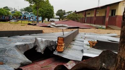 The damaged roof of a school lies in the playground in Vilanculos, Mozambique. AP