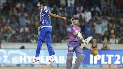 Mumbai Indians' Jasprit Bumra, left, celebrates the dismissal of Rising Pune Supergiant's MS Dhoni. Tsering Topgyal / AP Photo