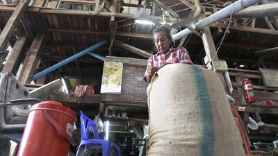 A worker packs rice at a mill in Suphan Buri province. Thailand offered about 208,000 metric tonnes of rice for sale as it attempts to unload huge stockpiles of the grain accumulated under a previous farm-subsidy programme.