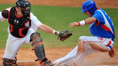 South Korea’s Lee Taek-kuen, right, beats the tag by Netherlands catcher Tjerk Smeets during the 2008 Beijing Olympic Games. Baseball could return to the 2020 Olympic Games in Tokyo, which could also see an increase in the number of sports disciplines. Frederic Brown / AFP