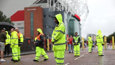Stewards outside the stadium before the match. Action Images