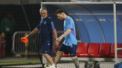 Lionel Messi walks alongside medical staff member Javier Martinez. Getty