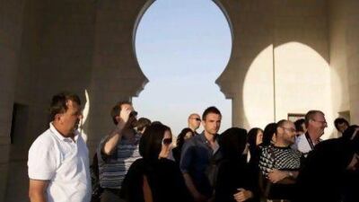 Travelers take a tour of the Sheikh Zayed bin Sultan Al Nahyan Mosque. Andrew Henderson / The National