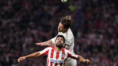 Atletico Madrid's Spanish forward Diego Costa jumps for the ball with Real Madrid's Spanish defender Sergio Ramos, top. AFP