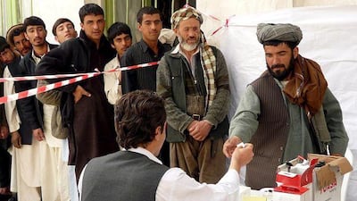 A man registers voters in Kunduz, northern Afghanistan, yesterday, as the country prepares for a second presidential election in August.
