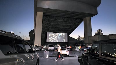 The drive-in cinema is making a comeback at Mall Of The Emirates, and a large screen has been assembled in the shopping centre's upper parking lot, on level 3, right underneath Ski Dubai's slope. Patrons take position, switch off their engines and settle in for the film. Reem Mohammed / The National