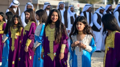 Girls prepare to perform at the Maritime Heritage Festival on Abu Dhabi Corniche, in 2023.