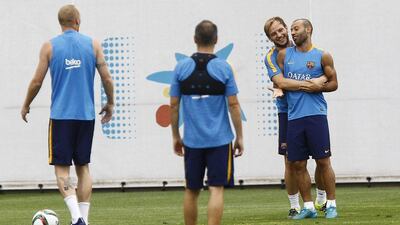 Barcelona's Ivan Rakitic jokes with Javier Mascherano on Thursday during the team training session ahead of the Spanish Super Cup. Quique Garcia / AFP