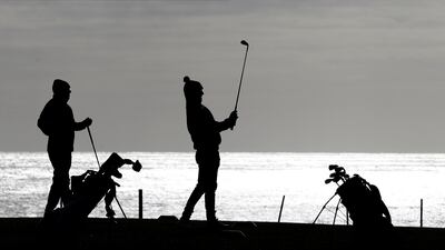 Golfers play a round of golf at Seahouses Golf Club in Northumberland. Reuters