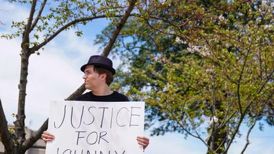Depp fan David Laman holds a poster outside the Fairfax County Circuit Courthouse as jury selection progressed. Reuters
