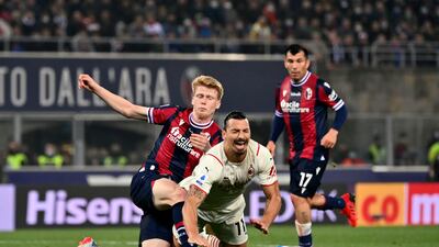 AC Milan's Zlatan Ibrahimovic goes down under a challenge from Bologna's Jerdy Schouten during the Serie A match at Renato Dall'Ara stadium in Bologna, Italy, Saturday, October 23, 2021. AP
