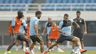 Sergio Aguero with Nicolas Otamendi of Manchester City in action during a training session of the 2016 International Champions Cup match between Manchester City and Manchester United at Olympic Sports Center Stadium on July 24, 2016 in Beijing, China. Lintao Zhang / Getty Images