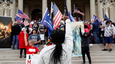 Protesters rally outside the State Capitol building after Joe Biden was declared the winner of the 2020 US presidential election, in Lansing, Michigan. Reuters