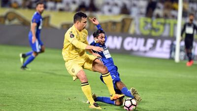 Fabio de Lima of Al Wasl, left, fought back a tough challenge from Al Nasr to help the team rally back and win 2-1 in their Arabian Gulf League match at the Al Maktoum Stadium, Dubai. Courtesy Arshad Khan Aboobaker / Arabian Gulf League