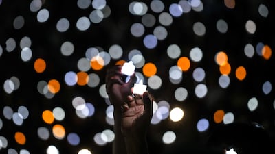 Christians hold candles on Christmas Eve at Indonesia Arena in Jakarta. AFP