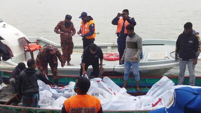 Firefighters and coast guards collect body bags of victims of the ferry fire near the southern rural town of Jholakathi, about 250 kilometres south of Dhaka. EPA