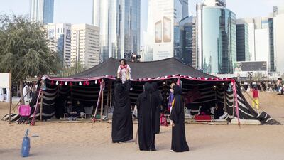 A group of women stand outside a tent during Qasr Al Hosn Festival. Reem Mohammed / The National