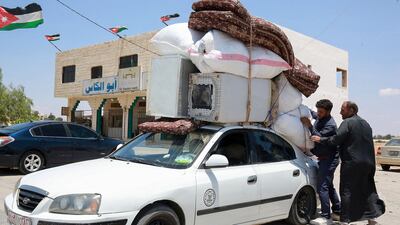 Syrians load a car with their belongings as they prepare to leave a refugee camp in Azraq, Jordan, to return to Deraa, southern Syria. AFP