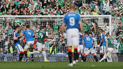 David Gray scores the third goal for Hibernian. Reuters / Russell Cheyne