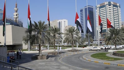 UAE flags are lowered at the Abu Dhabi Municipality offices. Ravindranath K / The National