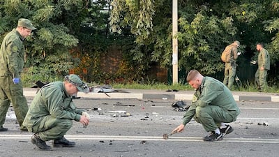 Investigators at the scene of a car bomb that killed Darya Dugina outside Moscow. Photo: Investigative Committee of Russia / AP