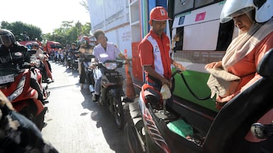 Residents of Banda Aceh, Indonesia, form a long queue at a petrol station, amid a sharp drop in oil production. EPA