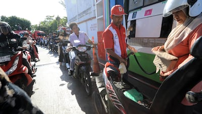 Residents of Banda Aceh, Indonesia, form a long queue at a petrol station, amid a sharp drop in oil production. EPA