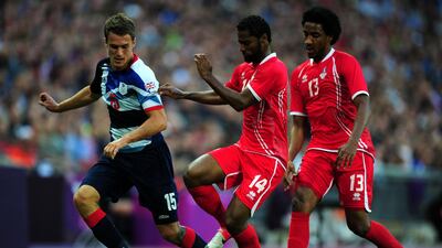 Aaron Ramsey of Great Britain controls the ball ahead of Abdelaziz Sanqour and Khamis Esmaeel of UAE. Getty Images