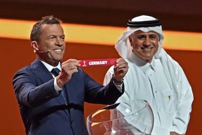 Former Germany player Lothar Matthaus show the paper showing the name of his country during the draw finals in Qatar. AFP