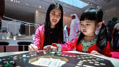 Visitors to Manarat Saadiyat play with Chinese Checkers at the launch of UAE- China Week. Victor Besa / The National