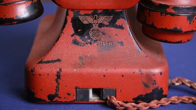 An engraving of a swastika and Adolf Hitler's name are seen on the back of Hitler's personal travelling telephone at Alexander Historical Auctions in Chesapeake City. The phone was sold at the auction for US$243,000 (Dh892,400) on on February 19, 2017. Patrick Semansky/AP Photo