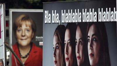 Election campaign posters of the German Christian Democratic party promoting Angela Merkel, left, and of the satirical party Die Partei (The Party), right, in Berlin on Friday. Michael Sohn / AP Photo