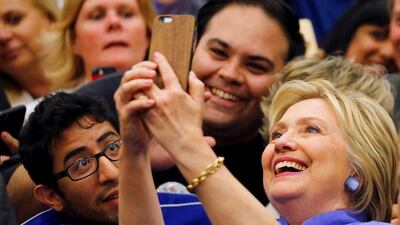 U.S. Democratic presidential candidate Hillary Clinton takes a selfie with supporters during a campaign stop in San Bernardino, California, US (REUTERS/Mike Blake)