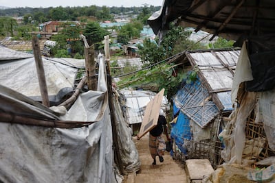 A Rohingya refugee man carries a solar panel at the Balukhali refugee camp, in Cox's Bazar, Bangladesh, September 28. Reuters