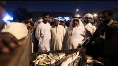 Mohammed Saif Al Suwaidi, manager of Dubai Fishermen's Cooperative Association, educates trainee inspectors about catches at the fish market in Deira.