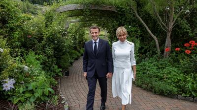 Brigitte Macron, the wife of the French President Emmanuel Macron, arrived wearing a sophisticated white ensemble, featuring a funnel neck, shoulder buttons and a bias cut skirt. Reuters