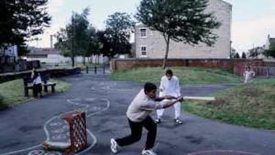 Children play cricket in a park in Manningham, an area of Bradford, England, with a predominantly Muslim population.