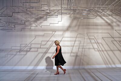 A woman walks past Nadia Kaabi-Linke's 'Flying Carpets,' one of the Abraaj Group Art Prize winners, during its unveiling at Art Dubai in 2011. Amy Leang / The National