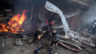 A handout image provided by the World Press Photo (WPP) organisation on 18 February 2016 shows a picture by photographer Abd Doumany that won Second Prize Stories in the General News Category of the 59th annual World Press Photo Contest, it was announced by the WPP Foundation in Amsterdam, The Netherlands on 18 February 2016. The picture shows a Syrian man carrying the body of a child killed in a reported air raid by government forces in the rebel-held area of Douma, east of the capital Damascus, 07 November 2015. Abd Doumany / EPA