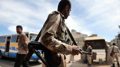 Yemeni soldiers manning a checkpoint at a street in Sanaa, yesterday. The government has moved to dissolve forces headed by rival army chiefs.