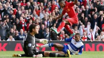 Raheem Sterling hurdles the challenge of Shaun Cummings, right, the Reading defender, as he scored his first goal for Liverpool to hand the club their first win at Anfield under manager Brendan Rodgers. Clive Brunskill / Getty Images