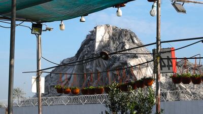 A pile of debris is all that remains from Mina Plaza, a complex of towers that stood incomplete for more than a decade. Victor Besa / The National