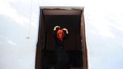 An Afghan patient dances in front of her room in the female ward.