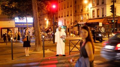 Lahcen, 41, waits to cross a street.