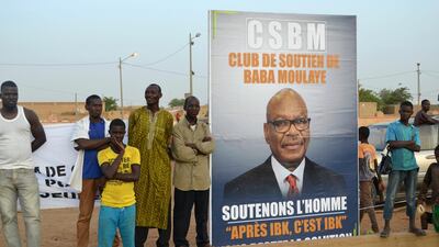 Supporters of Malian incumbent president Ibrahim Boubacar Keita wait at the Gao stadium on July 18, 2018 for a presidential campaign rally. AFP