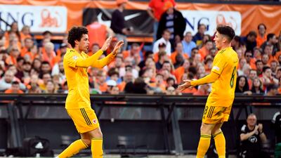 Brennan Johnson celebrates scoring their first goal with Harry Wilson. Reuters