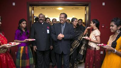 T P Seetharam, India’s new envoy to the UAE, centre, next to his wife, Deepa, meet members of the UAE’s Indian community at the India Social and Cultural Centre in Abu Dhabi on Saturday. Silvia Razgova / The National