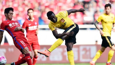 Jackson Martinez of Guangzhou Evergrande shoots during the Chinese Super League football match against Chongqing Lifan in Chongqing on March 6, 2016. AFP