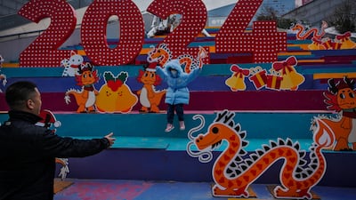 A child at a shopping mall displaying dragons in Beijing. 2024, is the Year of the Dragon on the Chinese calendar. AP